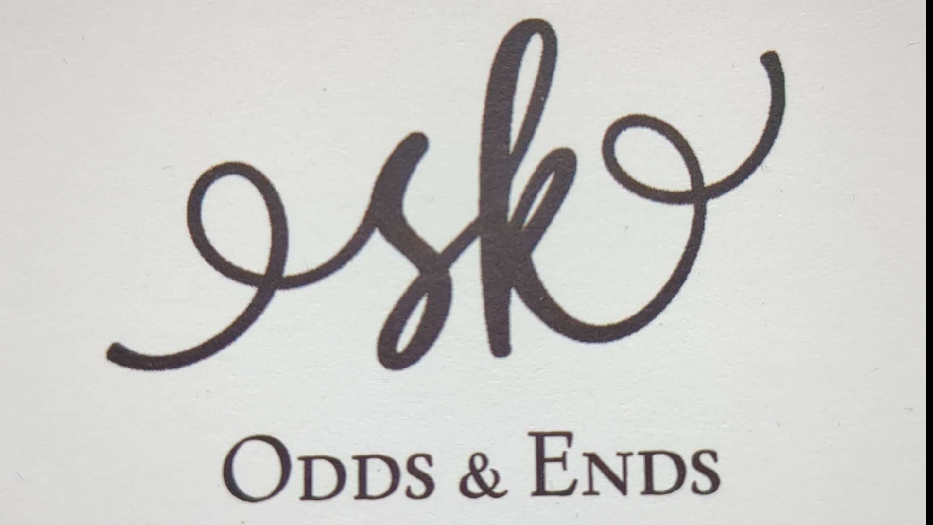 Minimalist thrift shop logo with calligraphic 