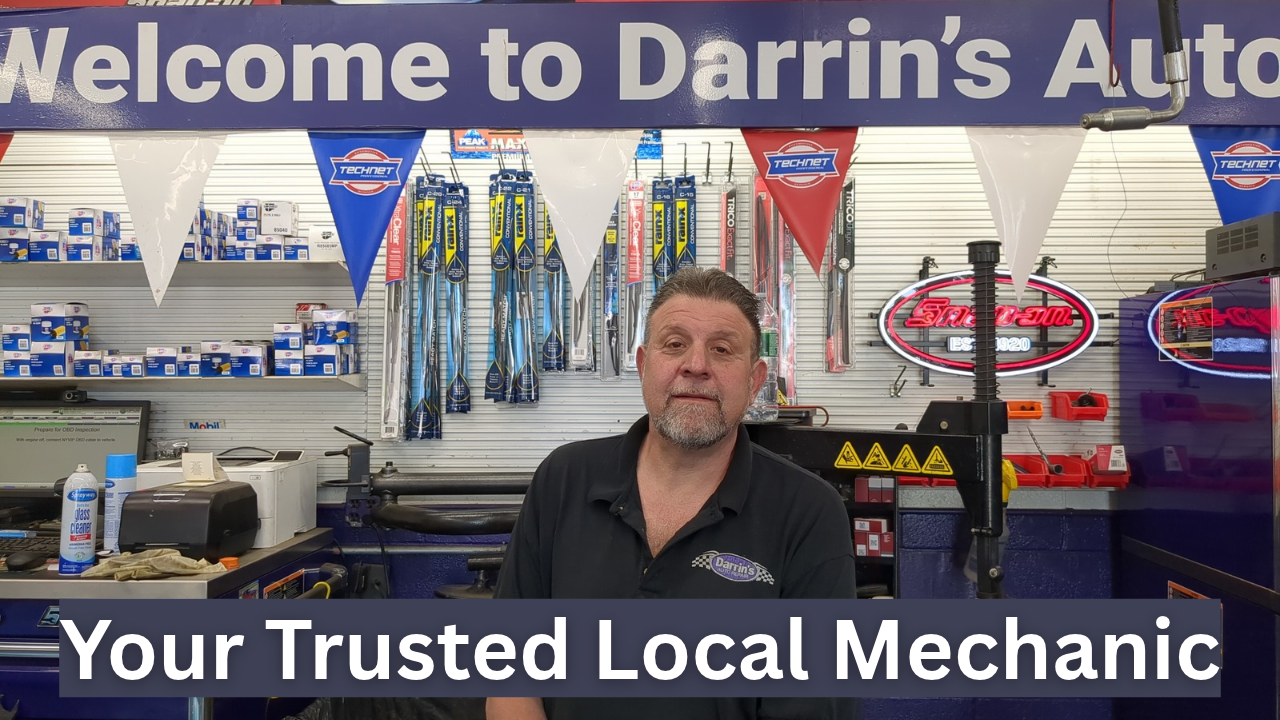 Darrin’s Auto Repair team standing by sedan highlighting Akebono brake service