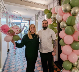Mark and Rebecca, owners of The Hidden Gem Coffee House, Tandragee, with first-anniversary balloons