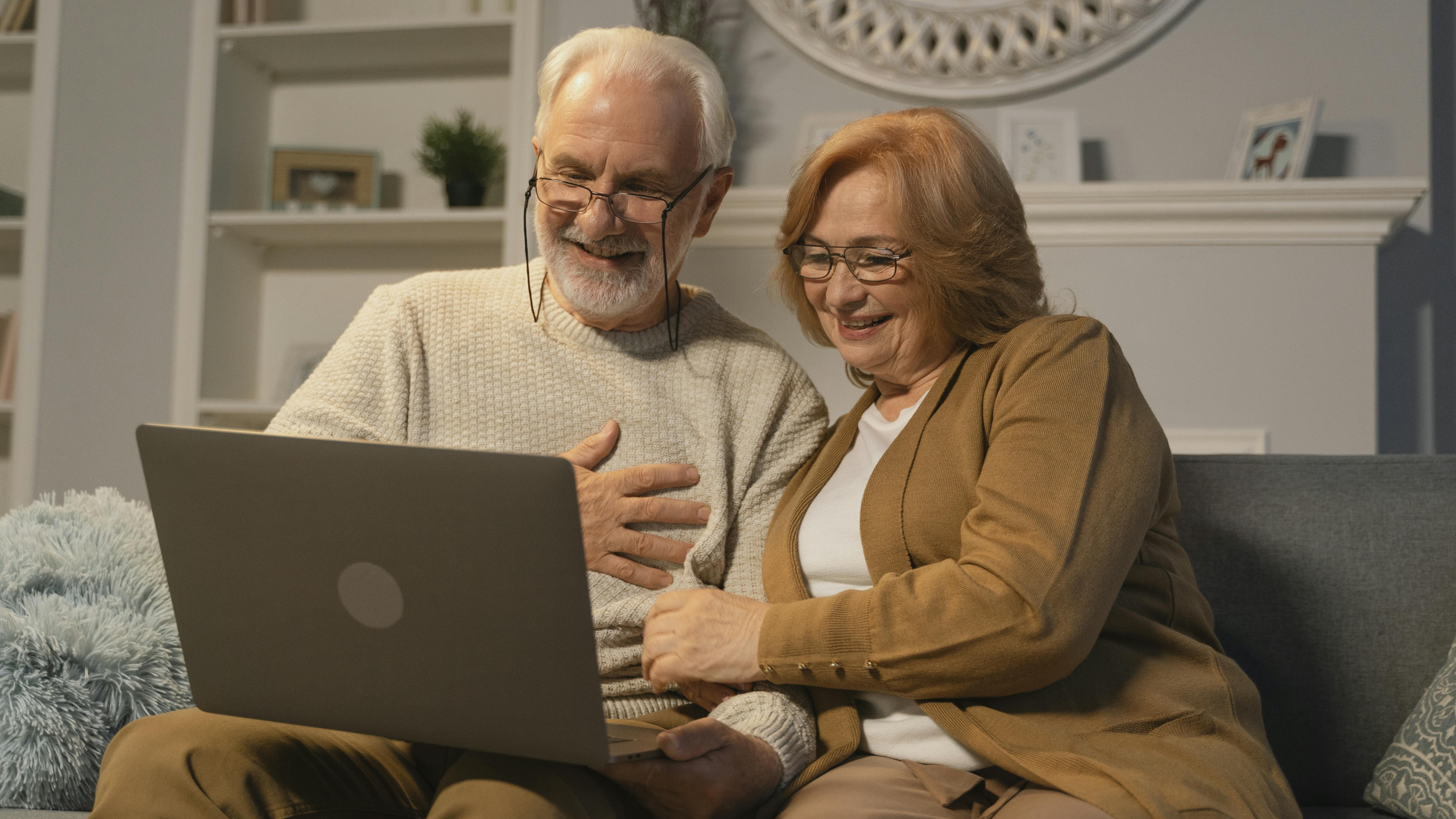 young couple, hopeful expressions, discussing retirement planning, photorealistic, contemporary living space with minimalist decor, highly detailed, digital tablet and notes, 35mm lens, bright colors, afternoon sunlight