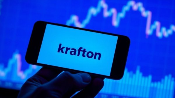 Krafton logo displayed on phone over financial chart background.