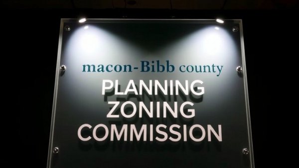 Macon-Bibb County Planning & Zoning Commission sign and logo indoors.