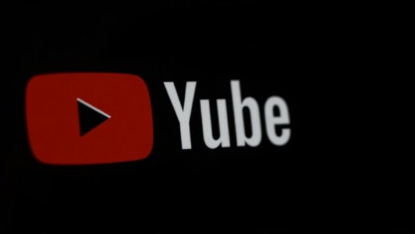 YouTube logo close-up in dark background.
