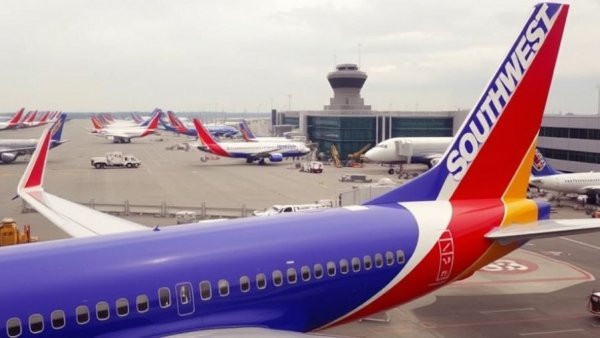 Southwest Airlines plane at airport promoting free checked bag on Southwest flights.
