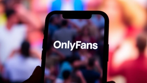 Close-up OnlyFans logo on phone with blurred colorful background.