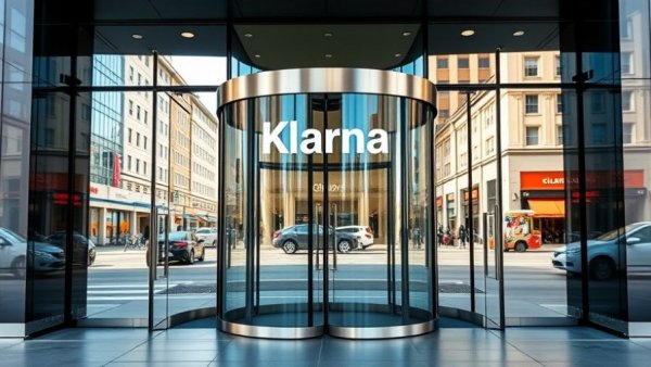 Klarna entrance with revolving doors reflecting urban scene.