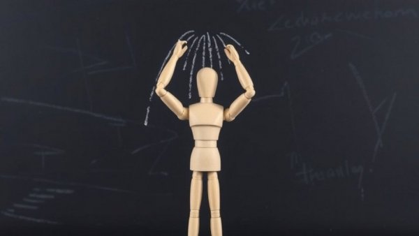 Wooden mannequin simulating showering with drawn water lines.