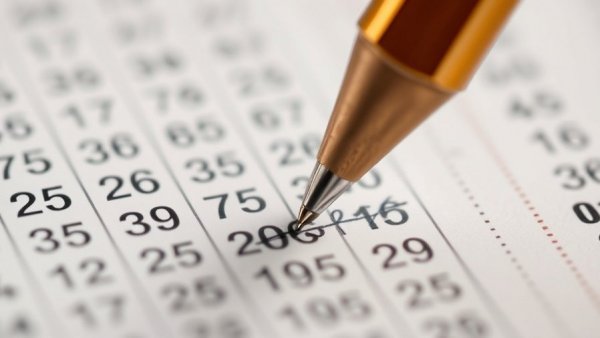 Close-up of a pen marking a Lotto 6aus49 Jackpot ticket.