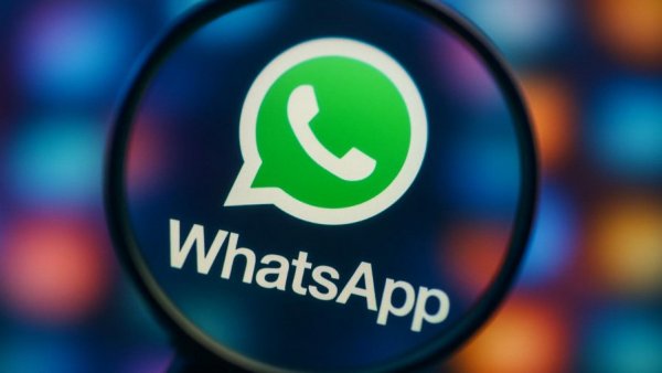 WhatsApp logo with magnifying effect, app screen.