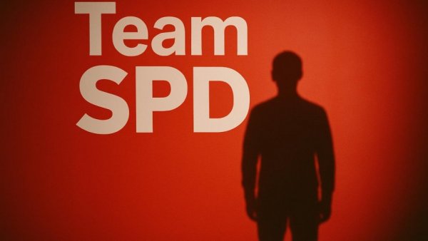 Silhouette against SPD logo on red background in political context.