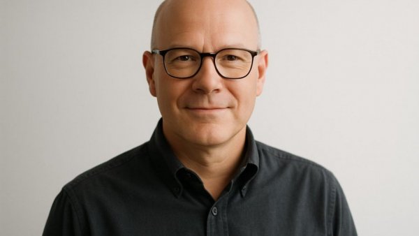 Confident man in glasses smiling, representing Commercial Lead Middle East