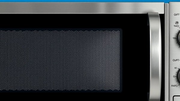Close-up of black dots on microwave door against blue background.