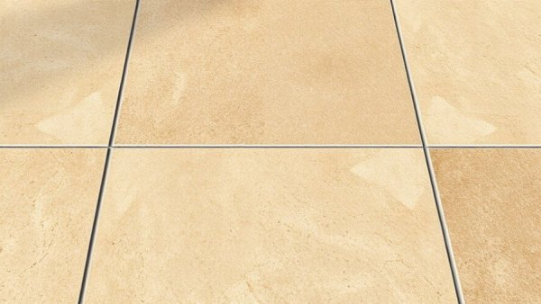 Close-up of beige linoleum floor tiles, natural stone look.