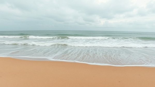 Peaceful Hamptons beach scene with gentle waves.