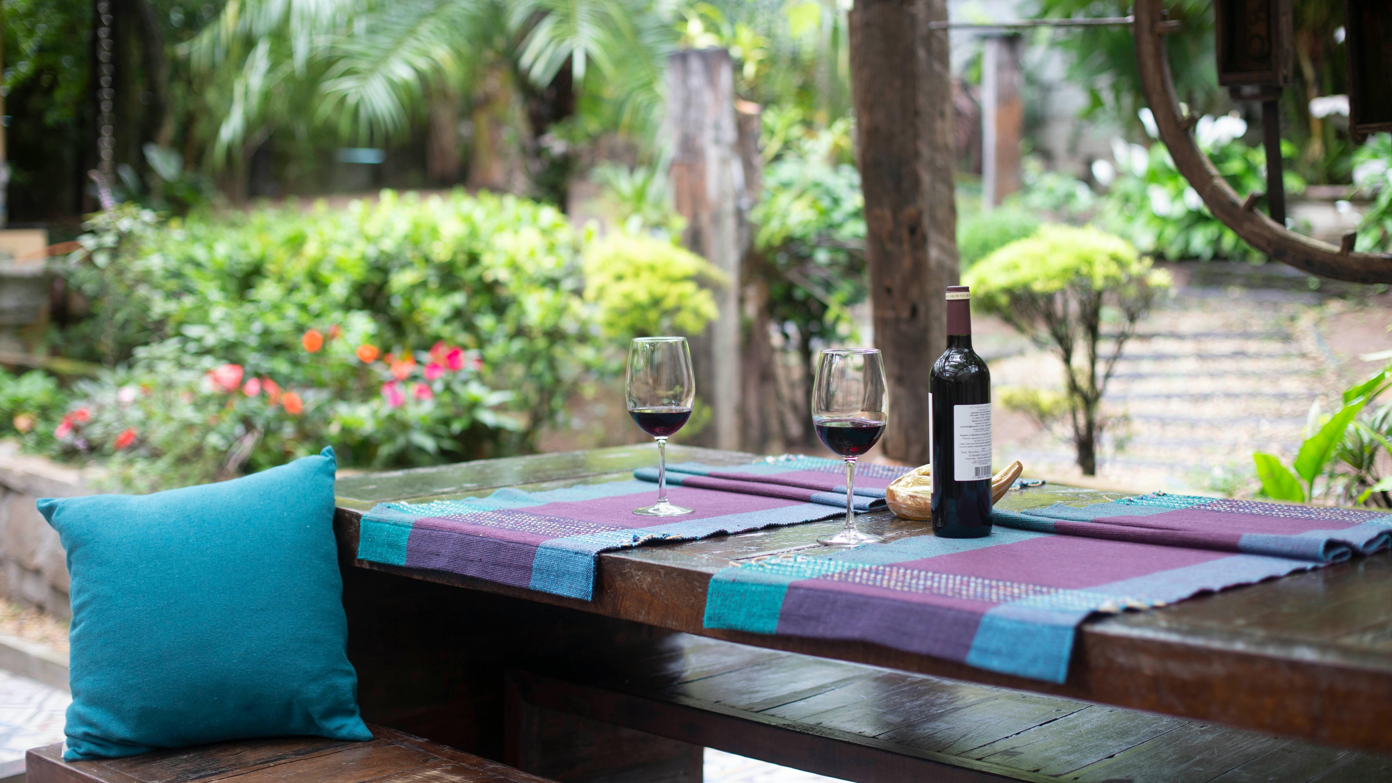Friends enjoying bocce ball in backyard entertainment setup.