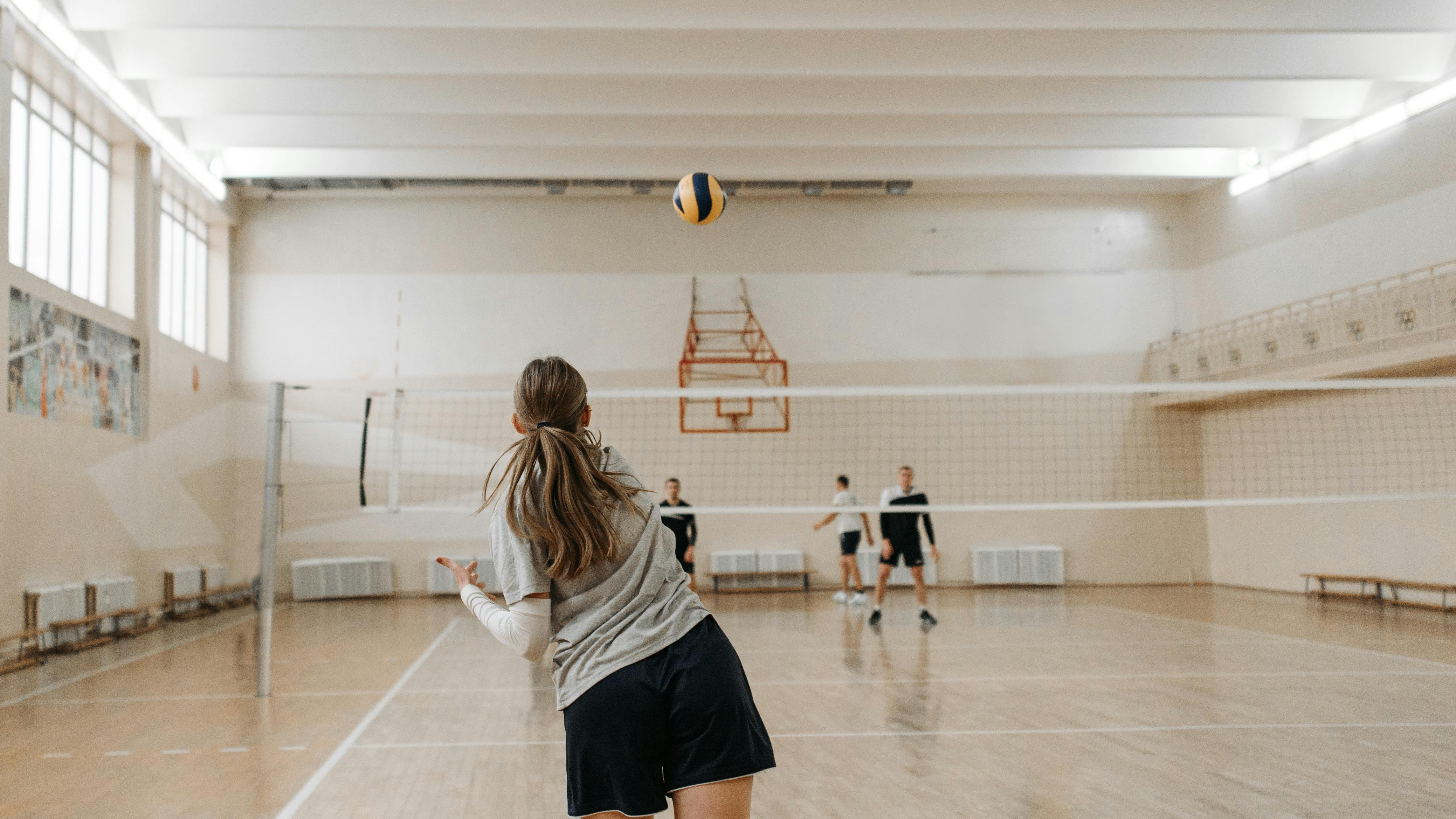Omaha Supernovas volleyball team celebrating playoff performance.