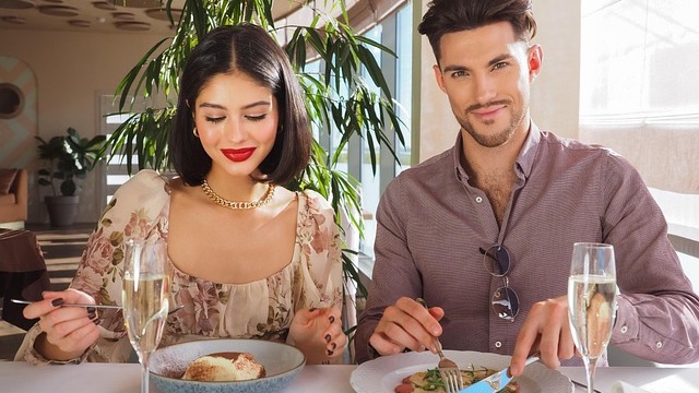 Couple sharing seafood at San Antonio restaurant, enjoying meal.