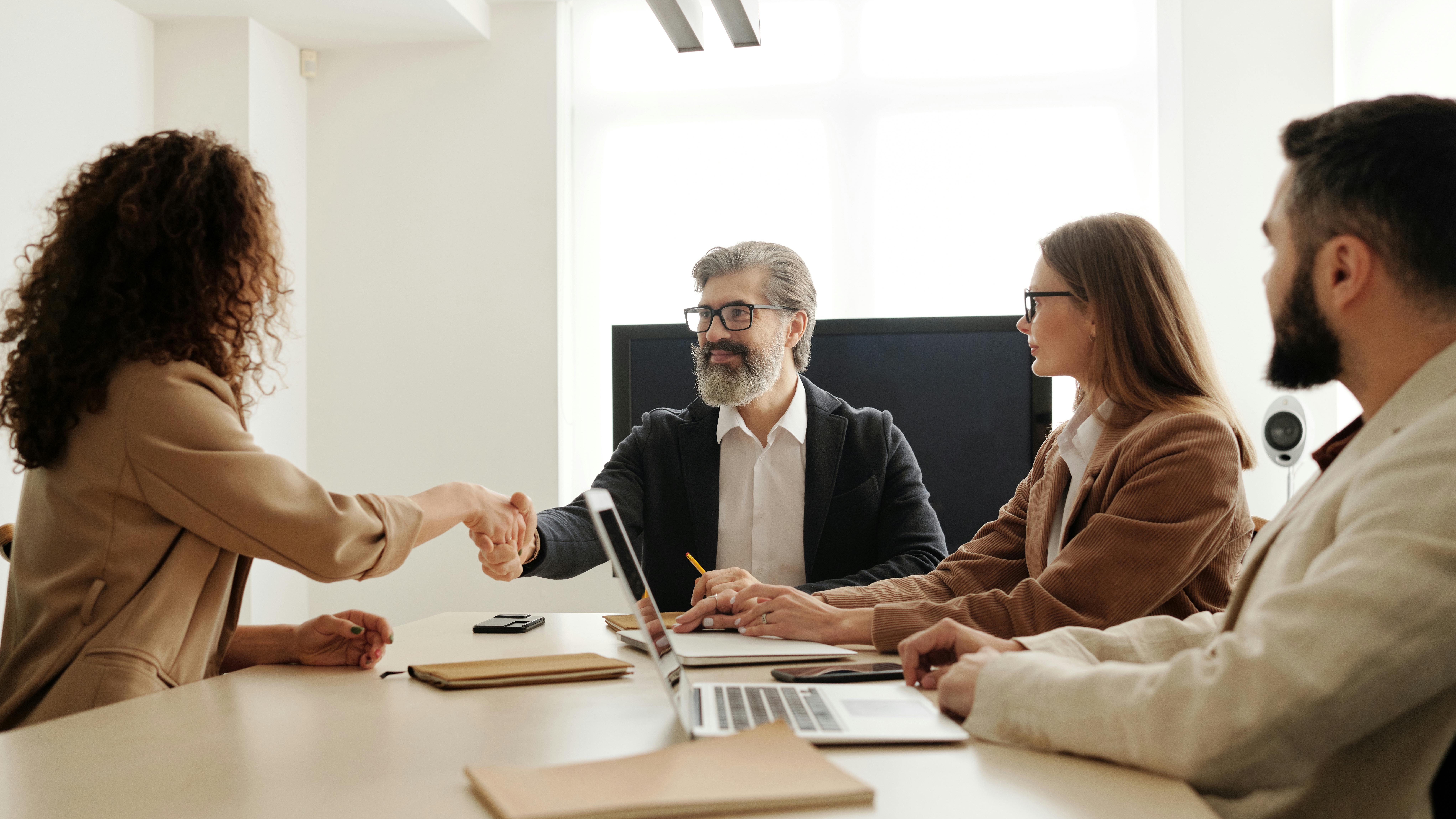 Confident woman in office setting discussing candidate experience.