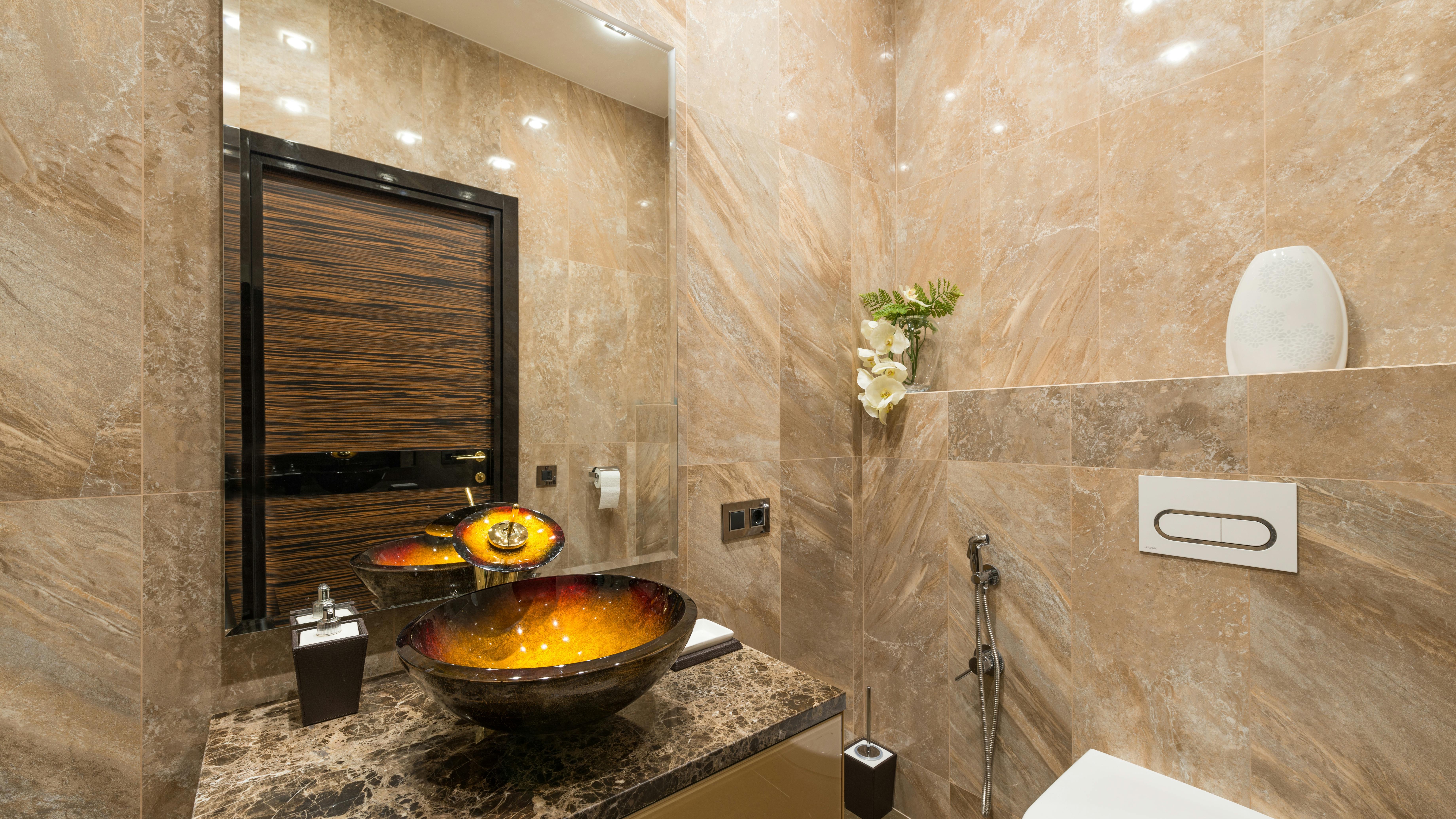 Chic modern bathroom with marble vanity and elegant decor.