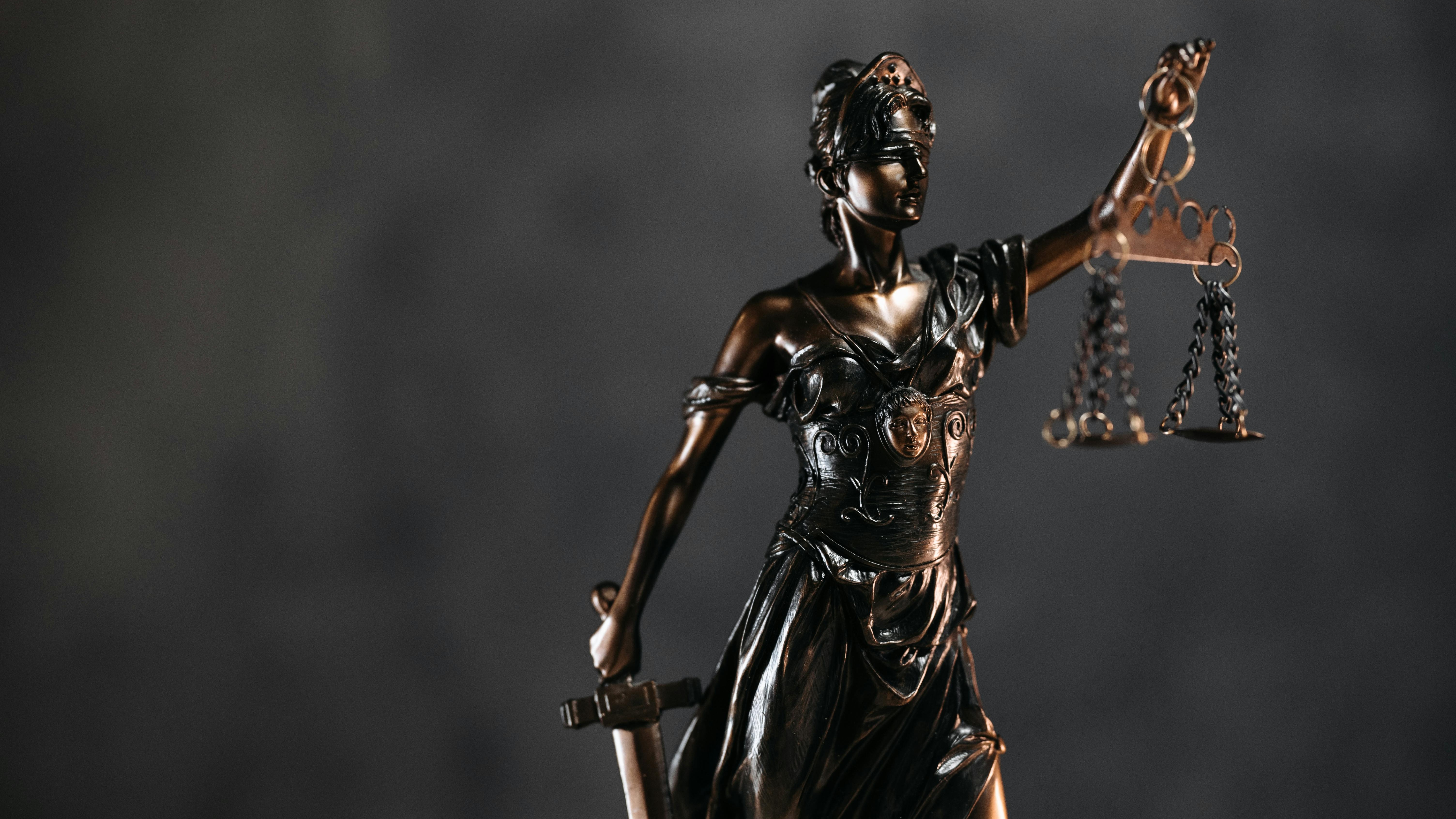 Digital representation of justice with gavel and scales in abstract setting.
