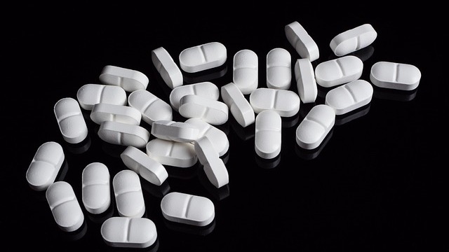 Prescription Drug Affordability: Pills and currency representing costs