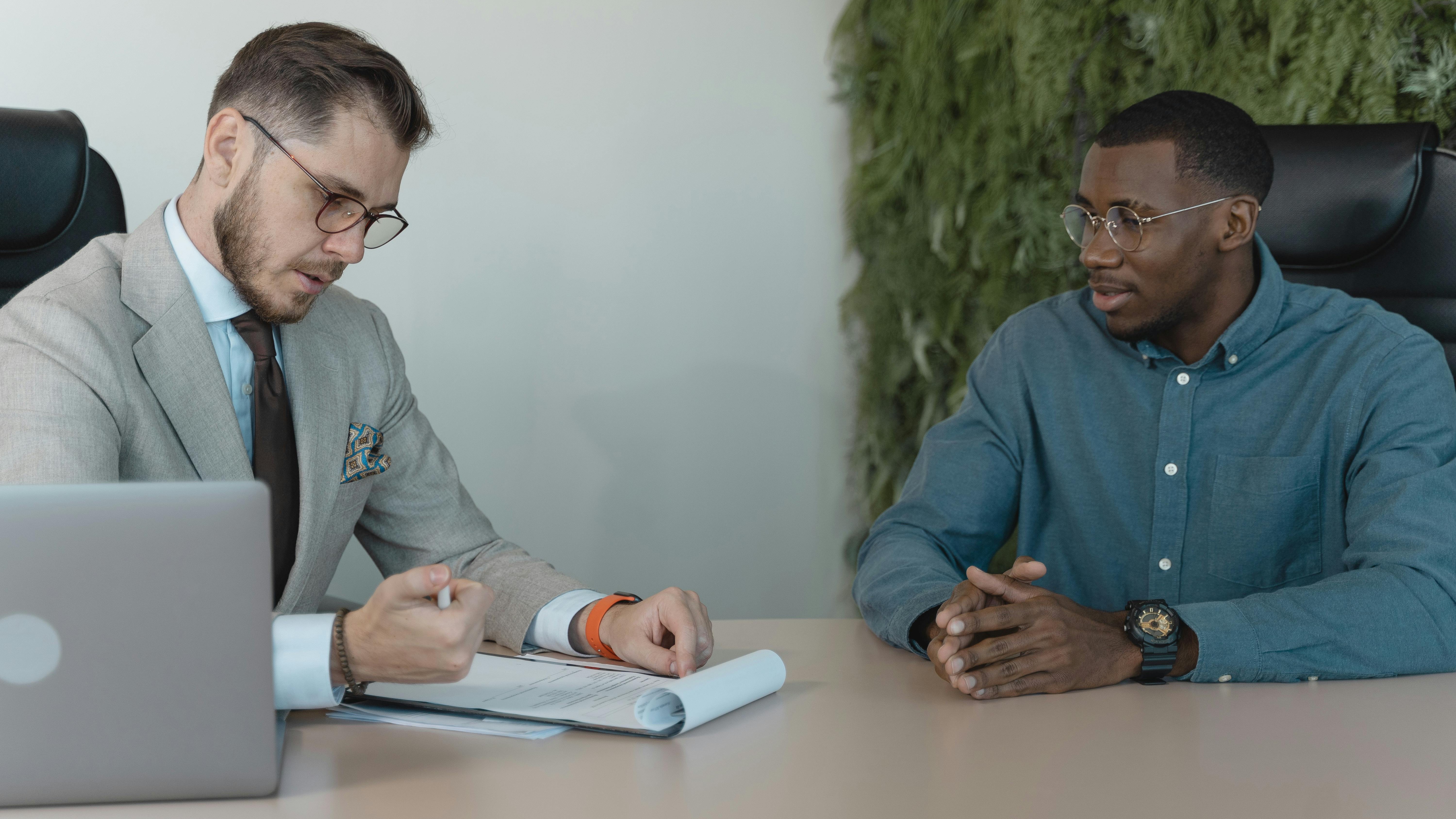 AI in recruiting: Woman in business attire shaking hands at an interview.