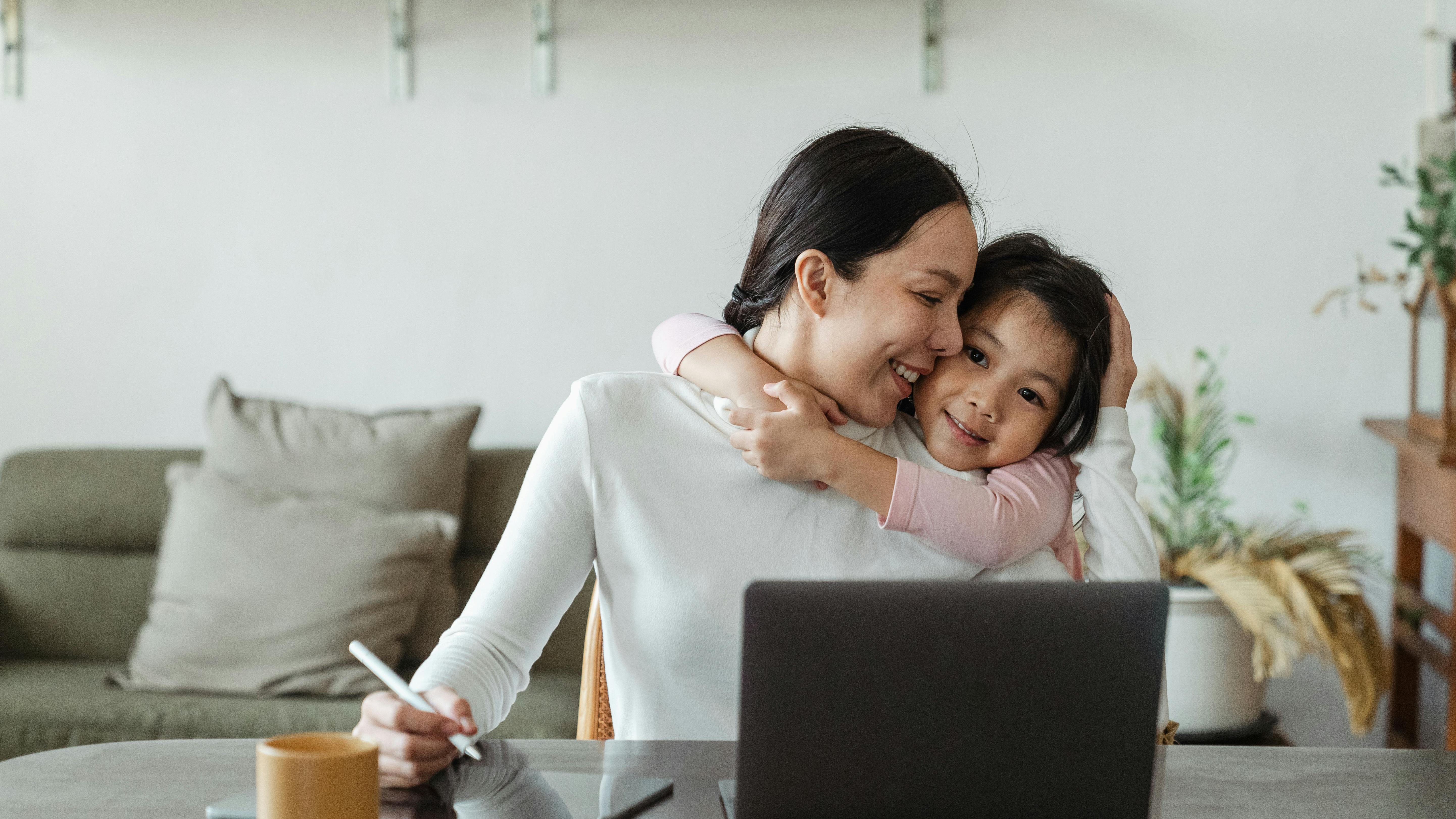 Professional woman in office packing, exploring working mom tips.