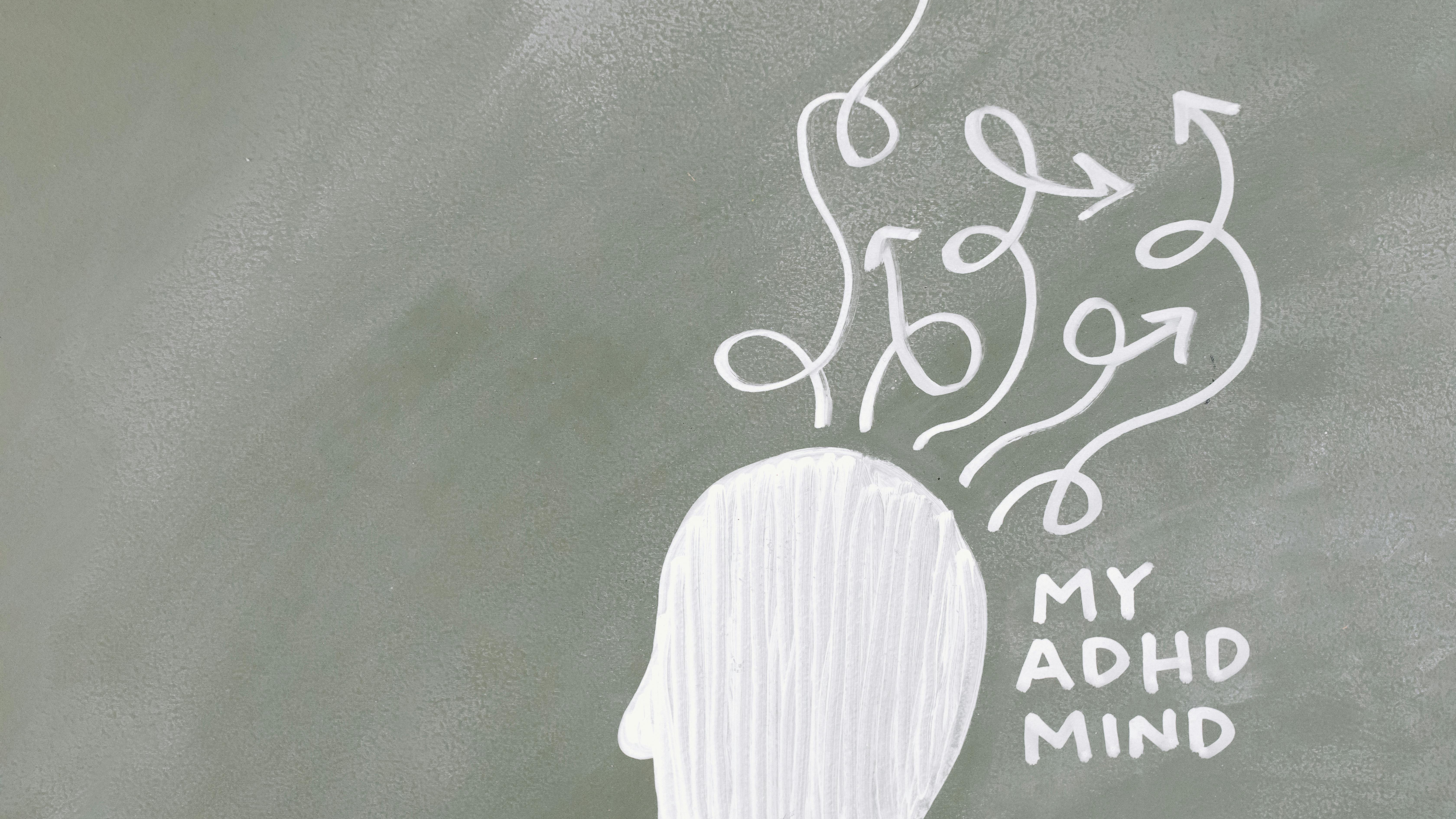 Woman reflecting at home desk, mental health focus.