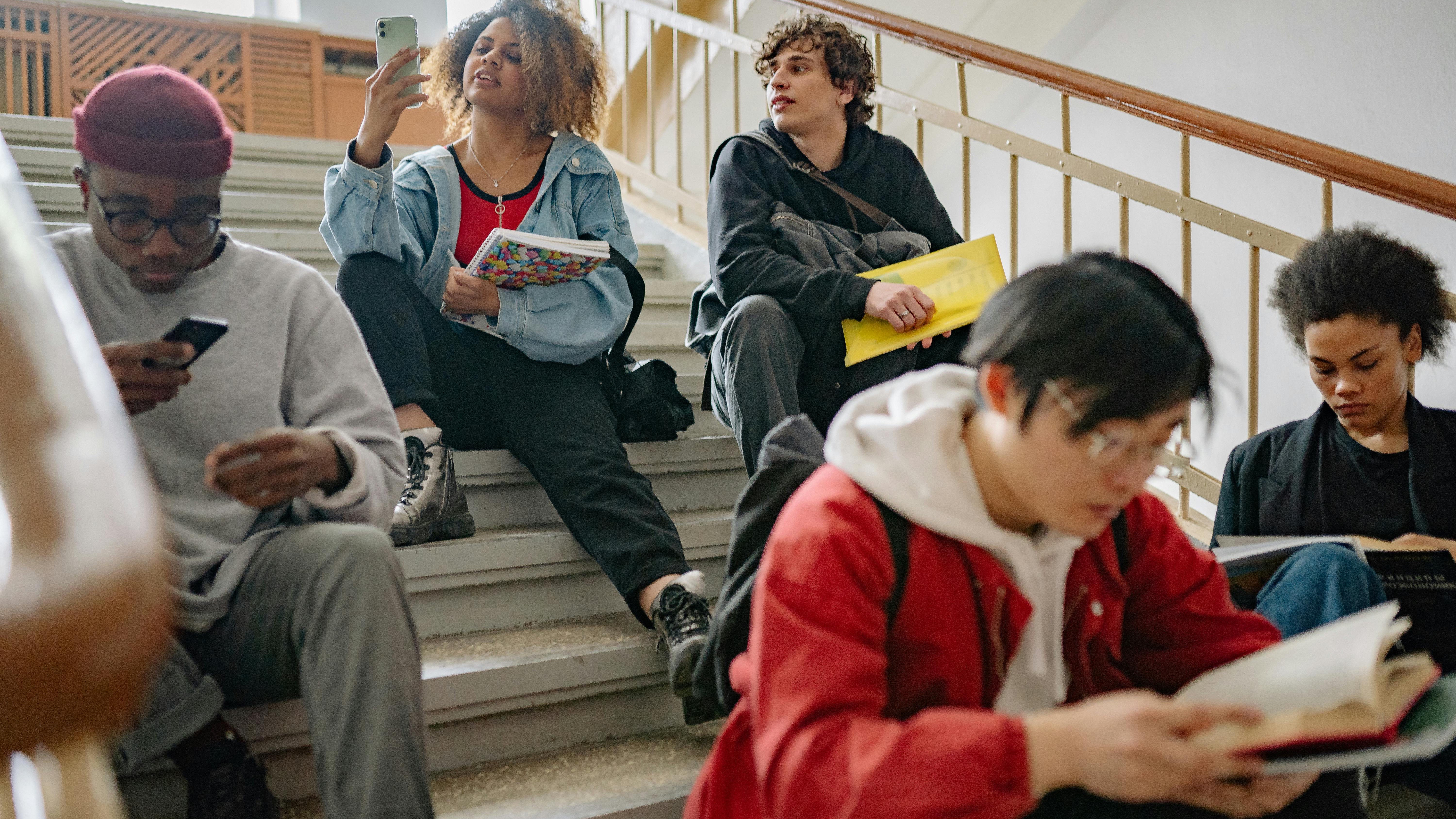College students walking on campus discussing financial options for veterans' children.
