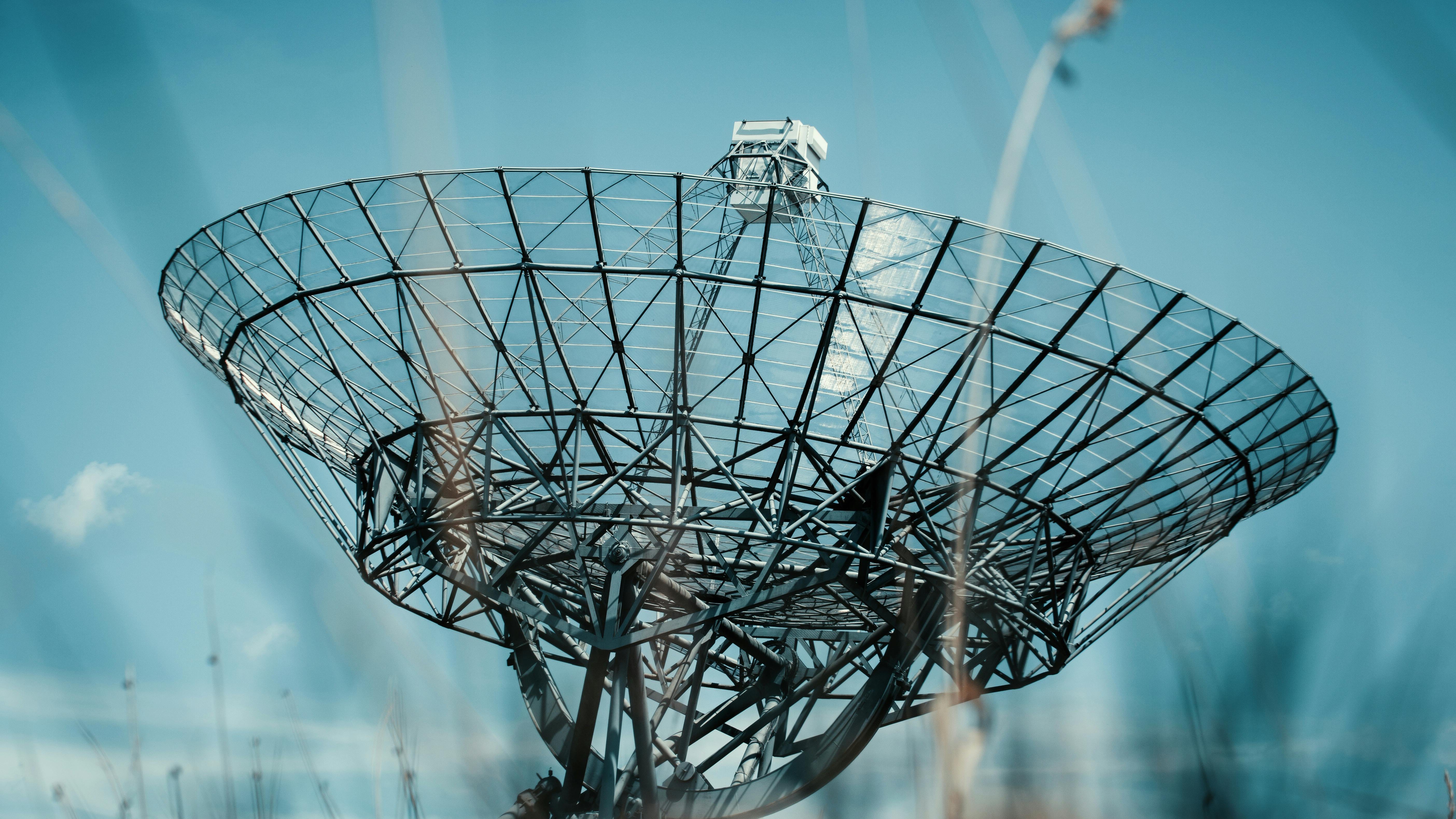 Satellite orbiting Earth in sunlight, Starlink Australia satellite market.