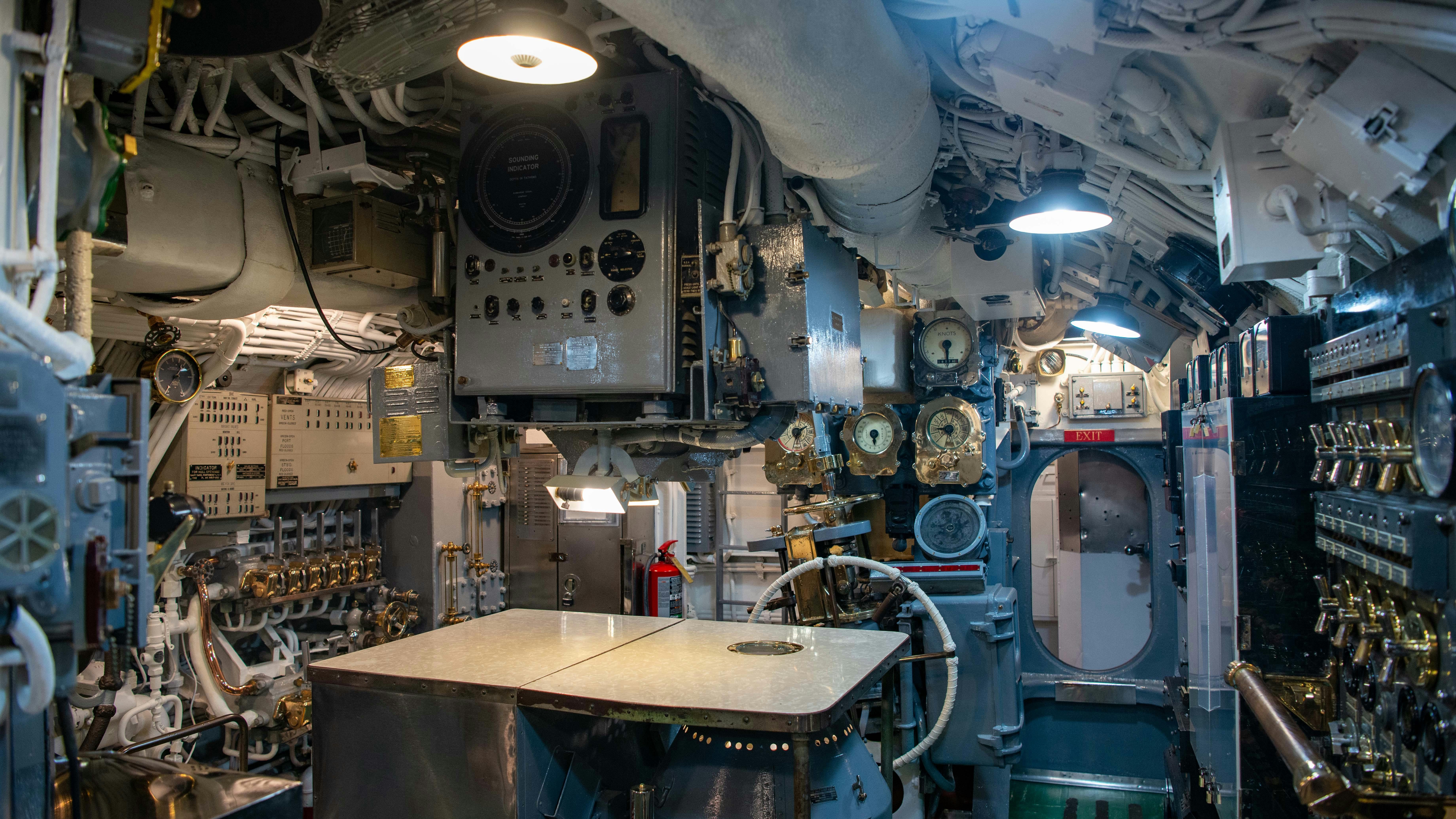 United States Navy emblem on dark blue; Navy submarine production contract.