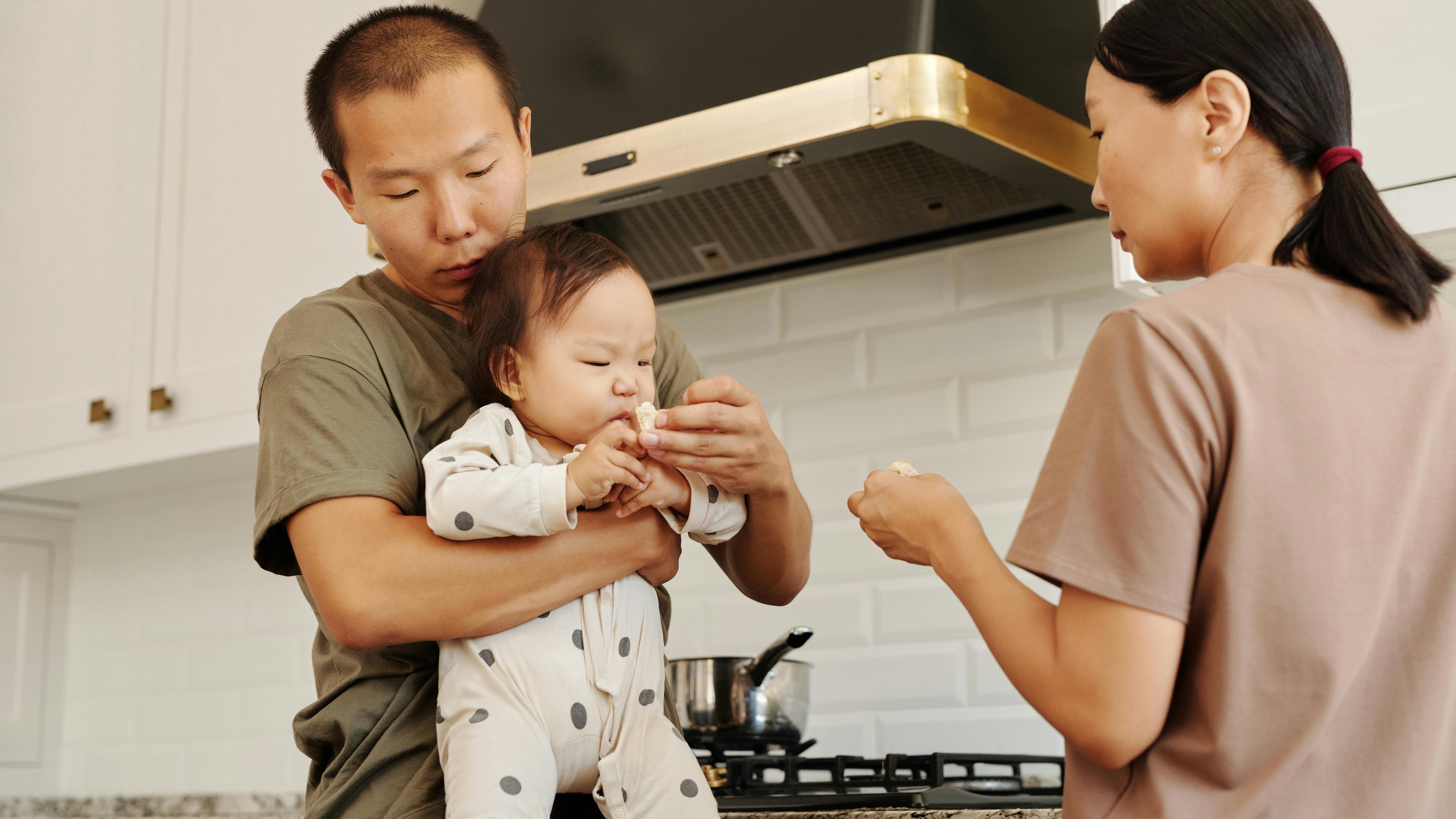 Father dressing newborn, highlighting Paid Family Leave Changes 2026