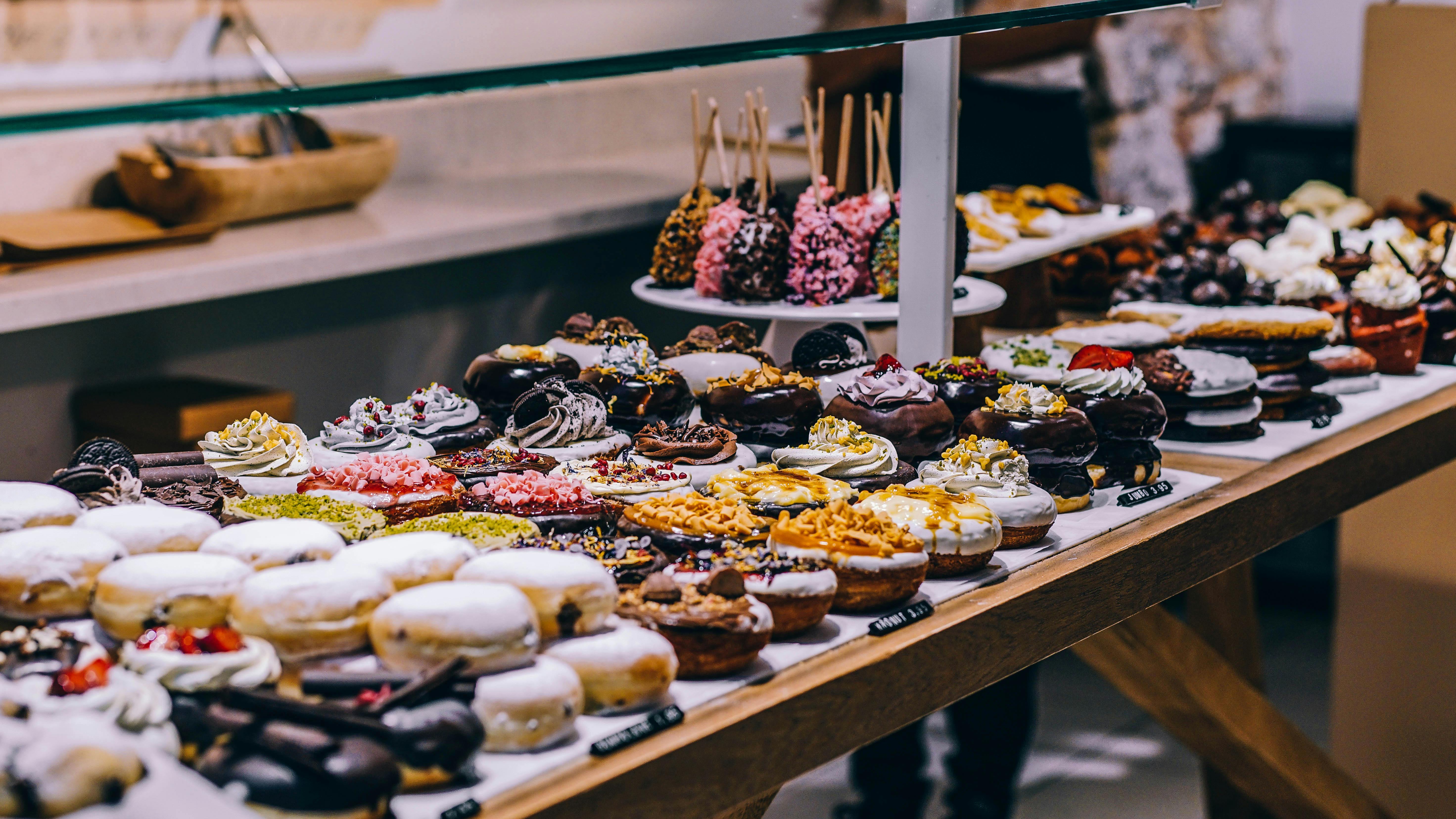 Colorful baked donuts with icing and sprinkles, creative display.