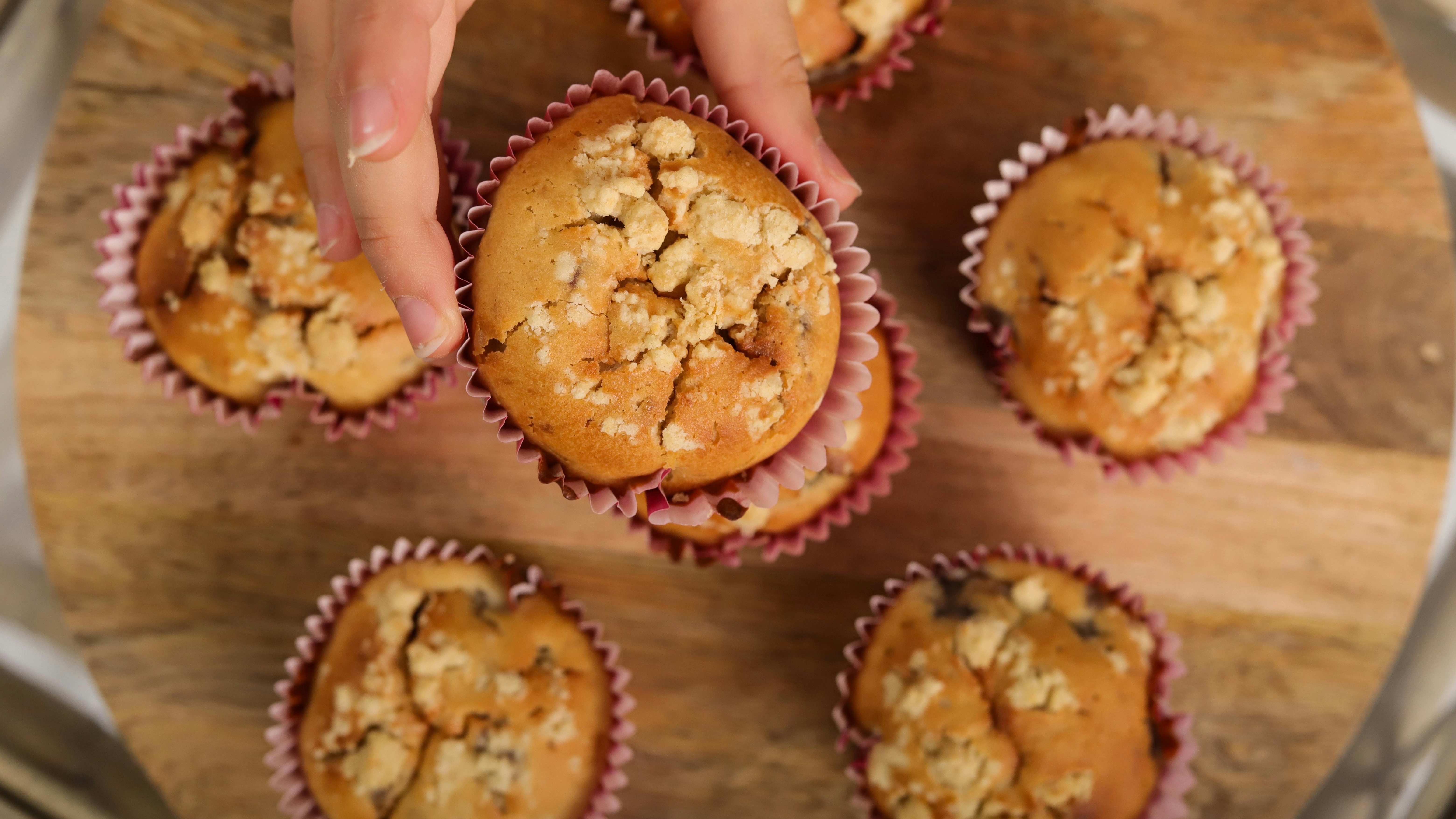 Assorted hidden veggie muffins on plates and racks.