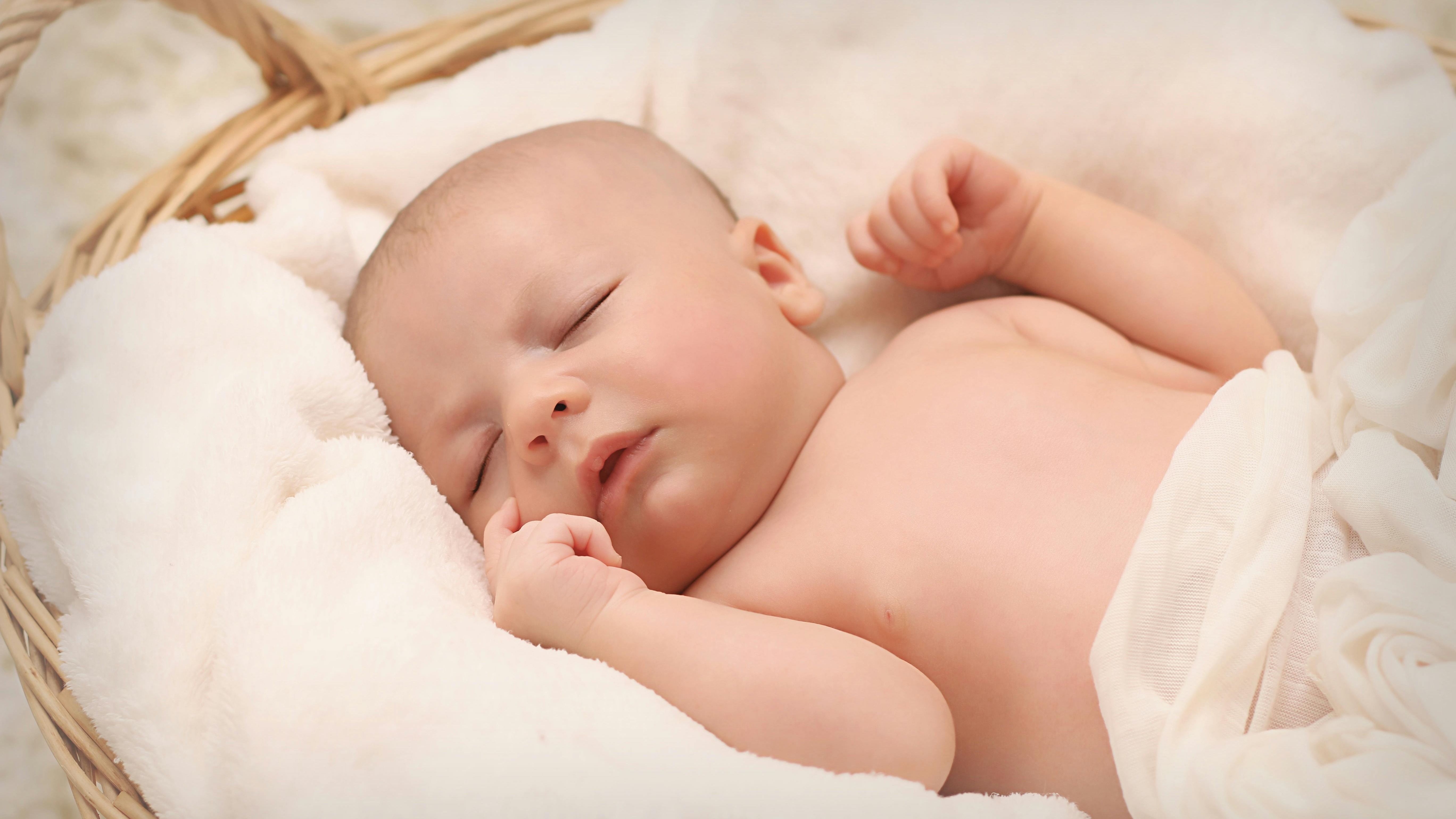 Gentle hands on pregnant belly, experiencing fetal hiccups.