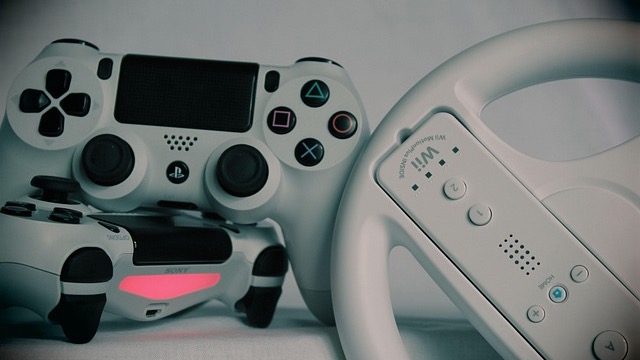 Close-up of gaming console with vibrant racing game display.