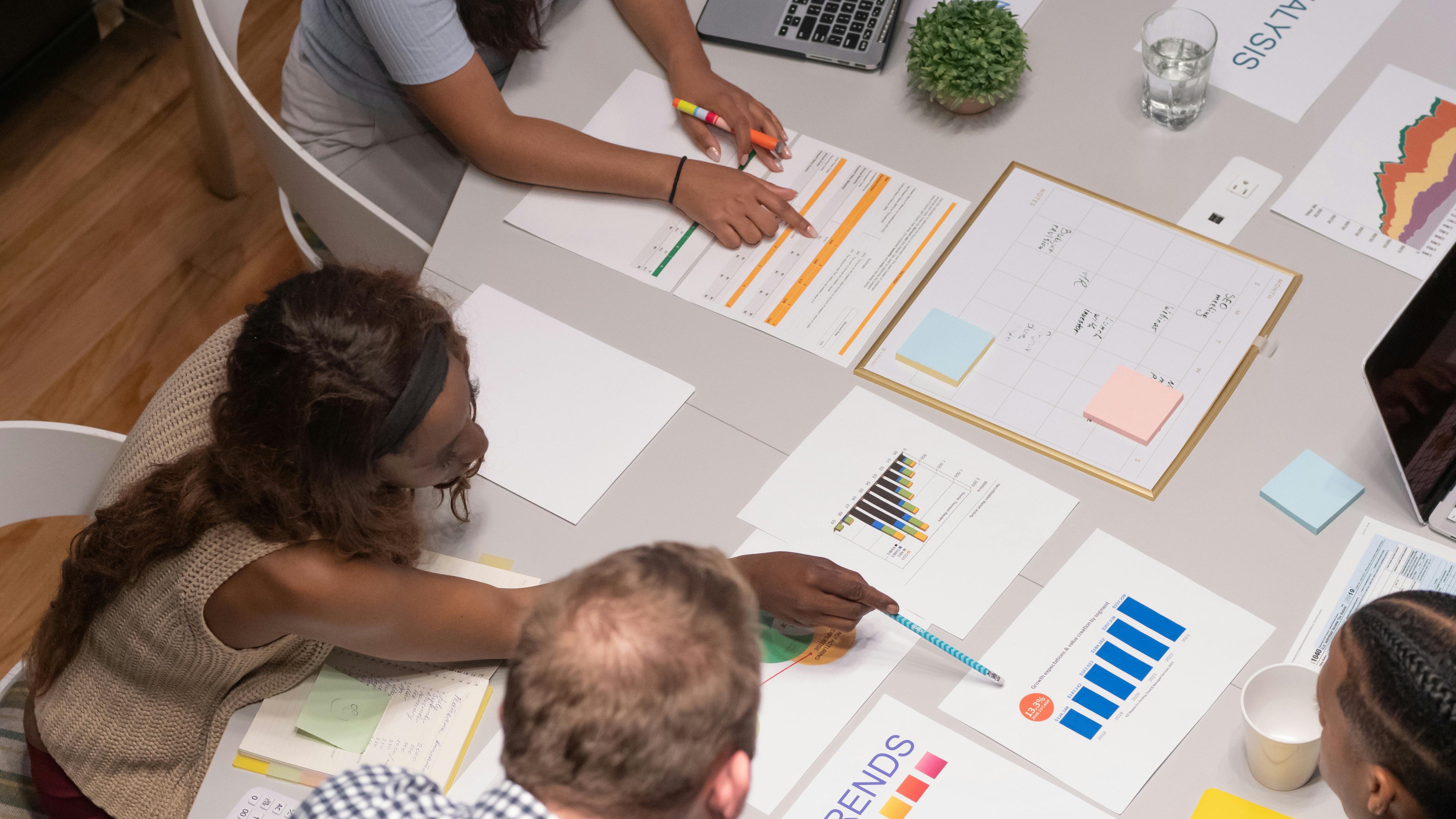Diverse group discussing in a modern office, highlighting Neurodiversity ERGs.