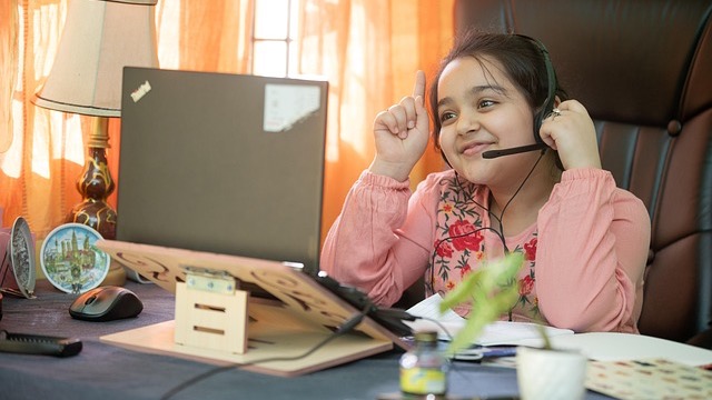 Child using AI learning assistant in a cozy bedroom setting.