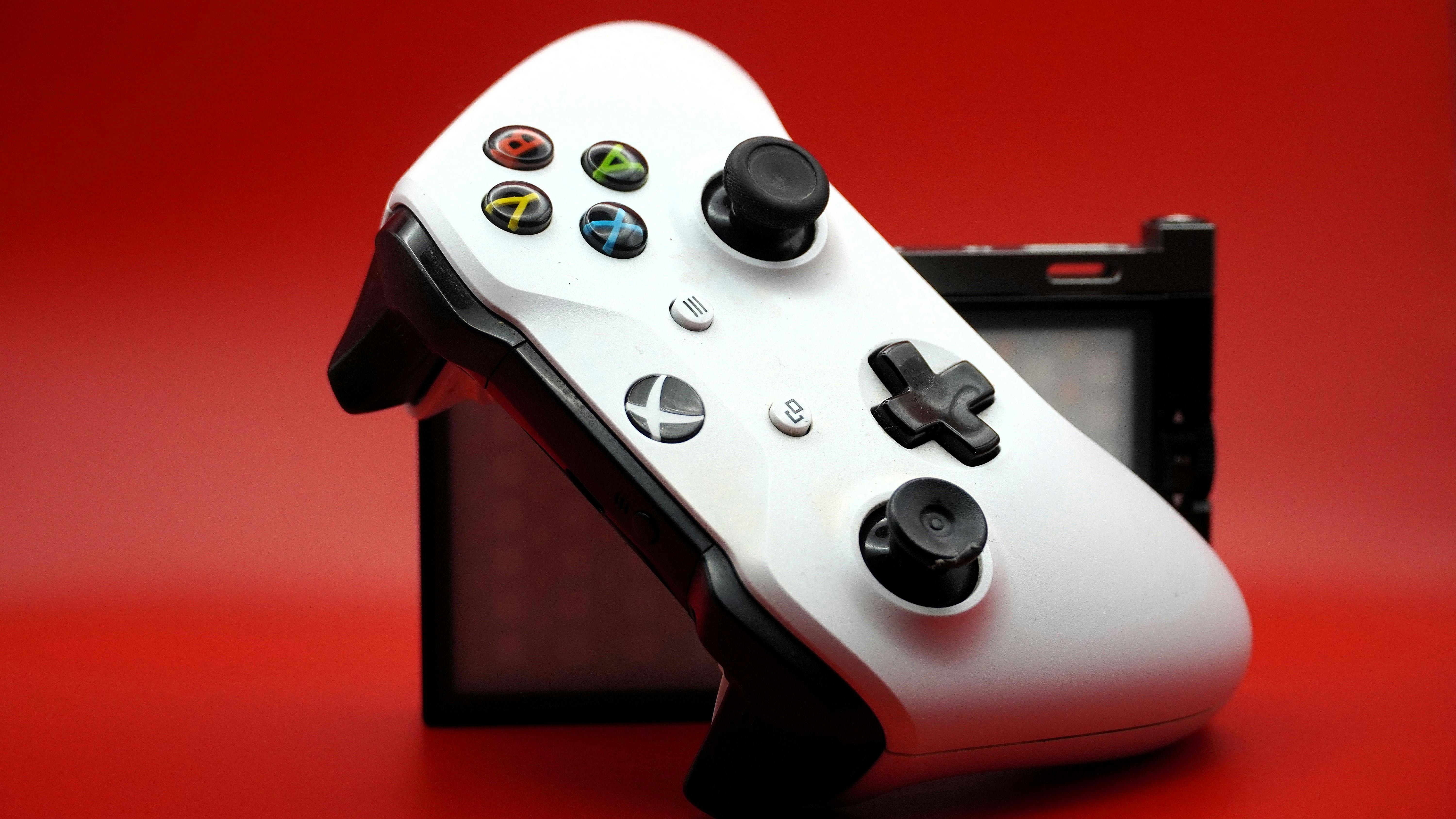 Wii U gamepad with Mario figure displaying a digital letter in a colorful setting.
