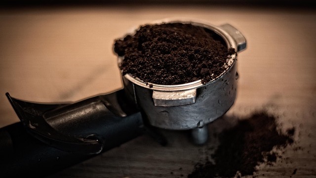 Close-up of barista using espresso machine in Omaha coffee shop.