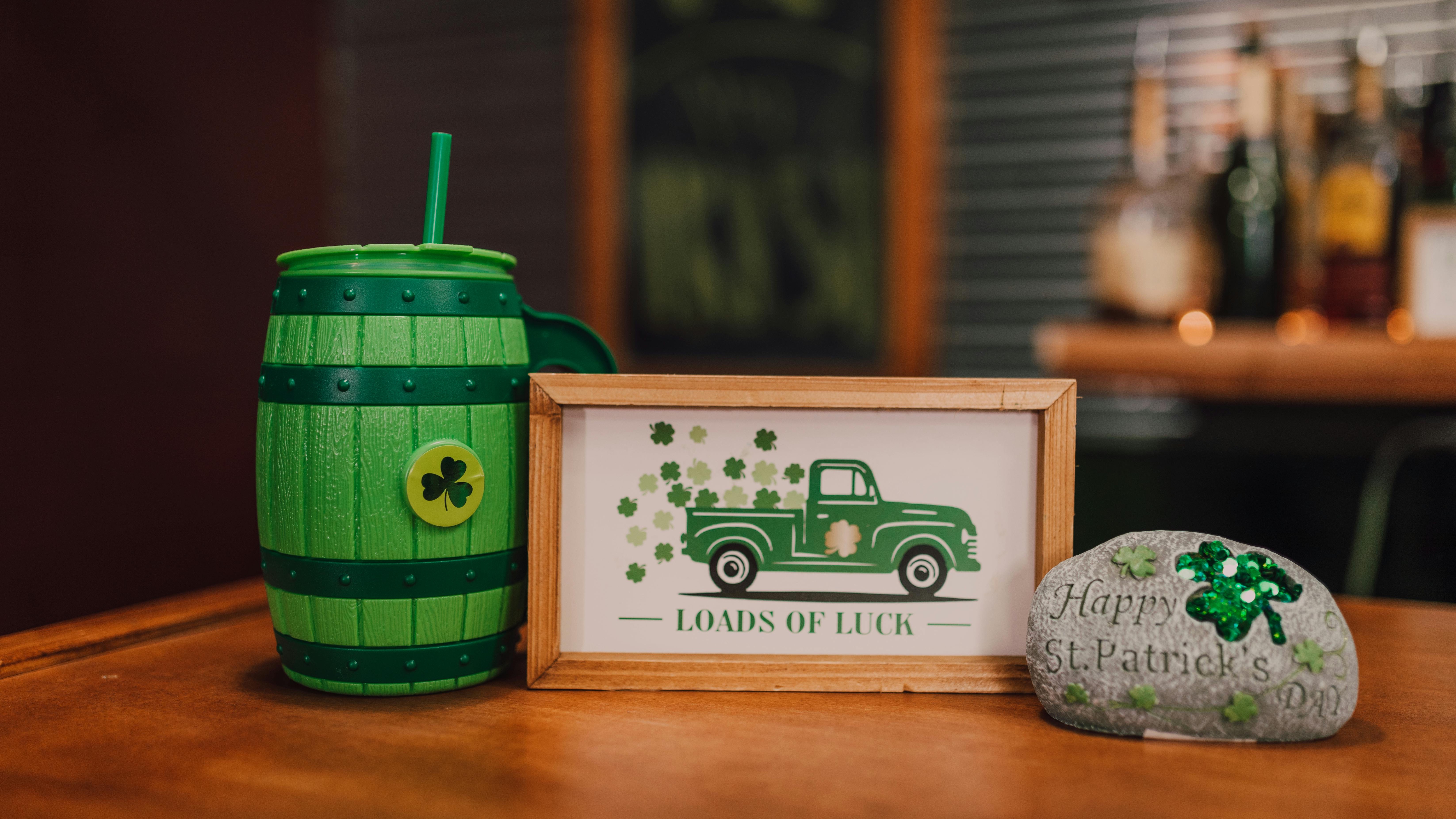 Green beer glasses with clovers and hat, Omaha St. Patrick's Day events.