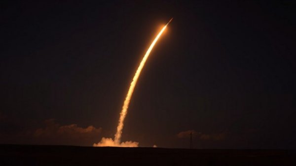 Missile launch at night with fiery trail, guarding America's nuclear missiles.