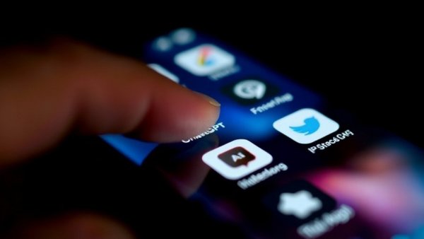 AI technologies on smartphone screen in dark setting, AI in recruiting.