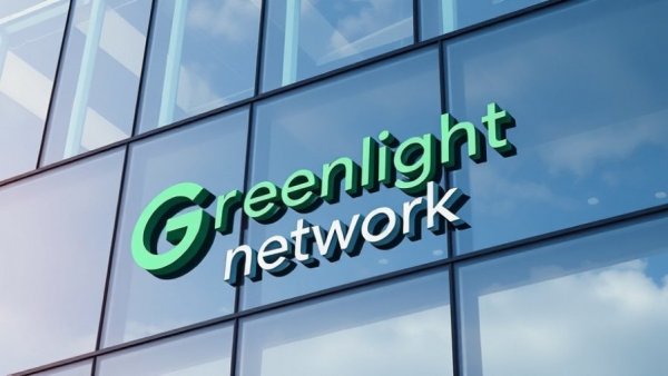 Close-up of Greenlight Networks logo on building, T-Mobile fiber internet.