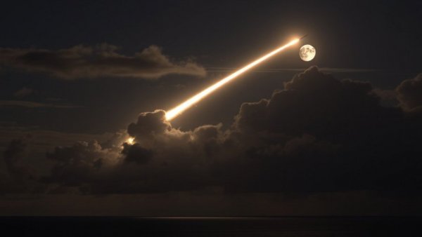 Aegis Guam missile defense upgrade: night missile launch with bright light trail.