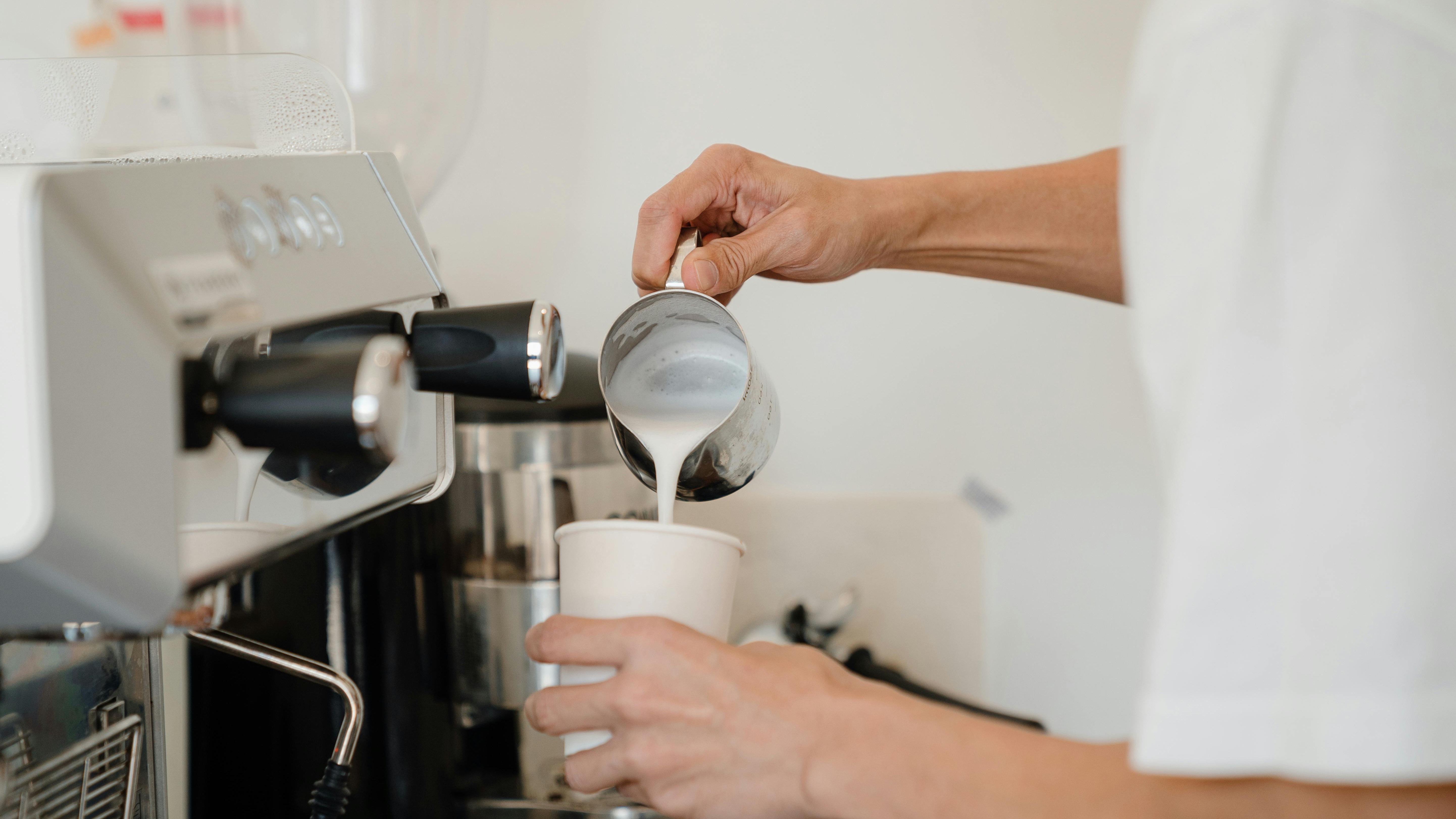 Smeg espresso machines brewing rich coffee in a sleek modern design.