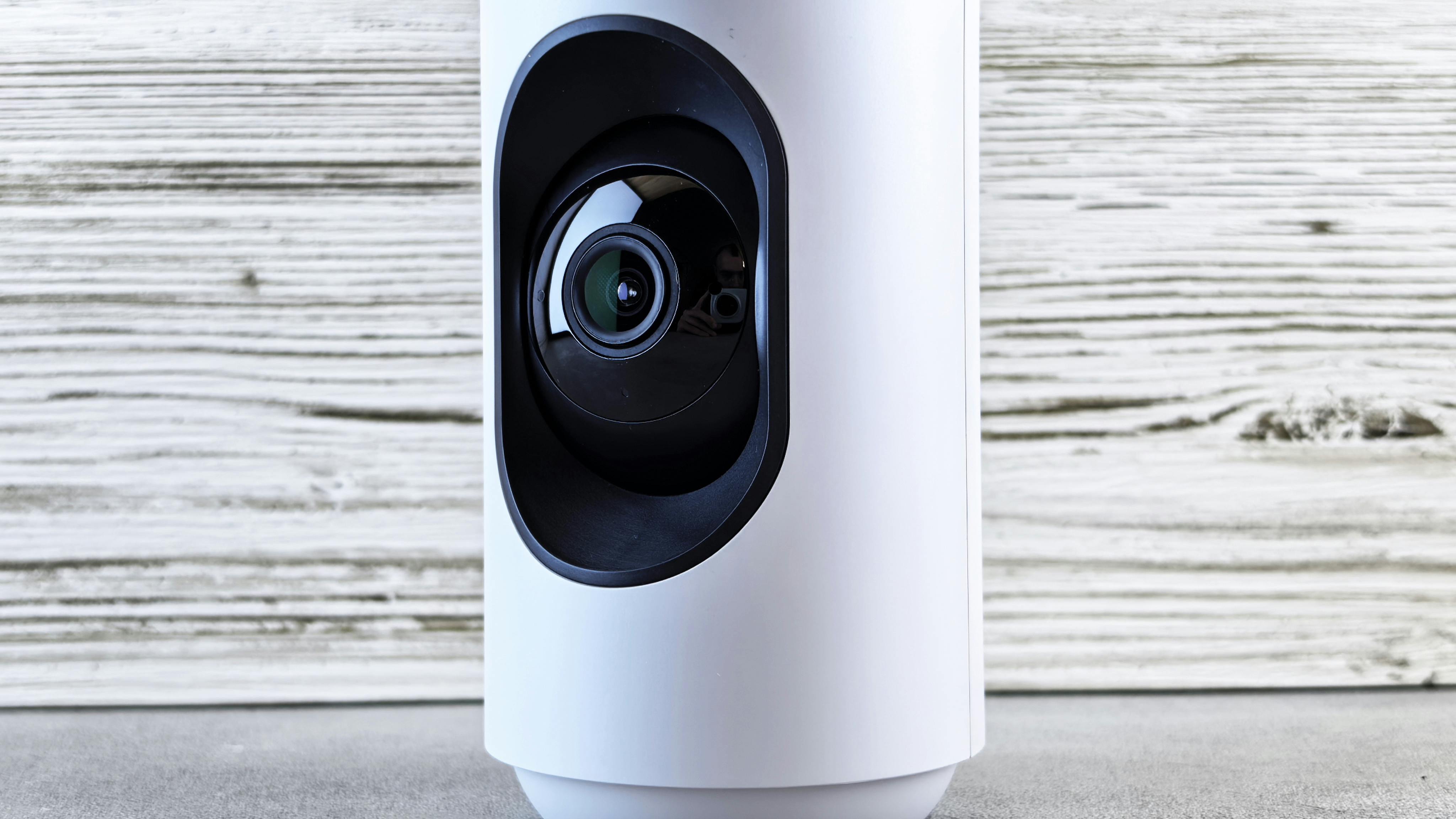 Affordable home security camera next to packaging on a shelf.