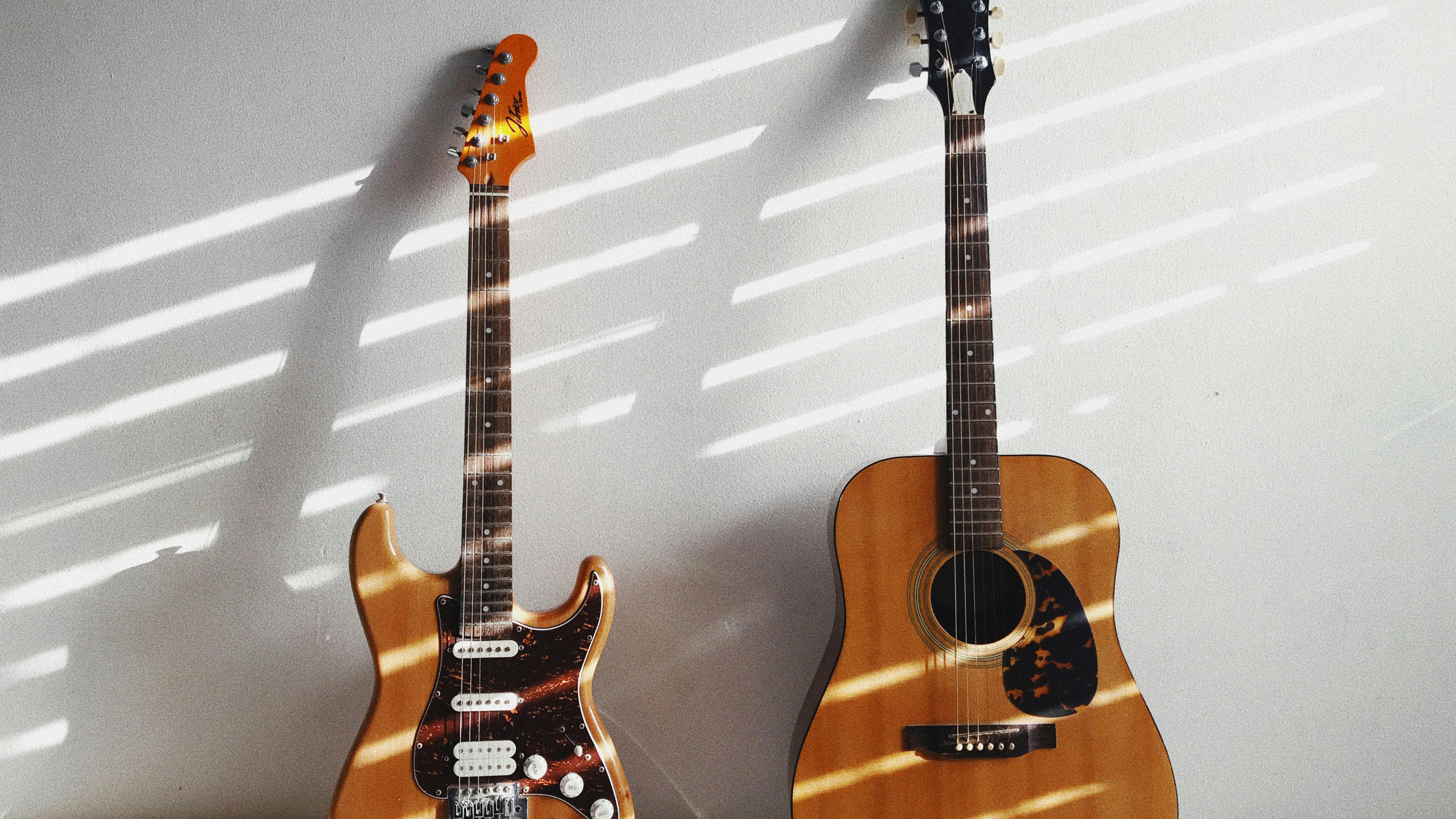 Philips Hue Omniglow lighting on guitars with pink and blue neon.