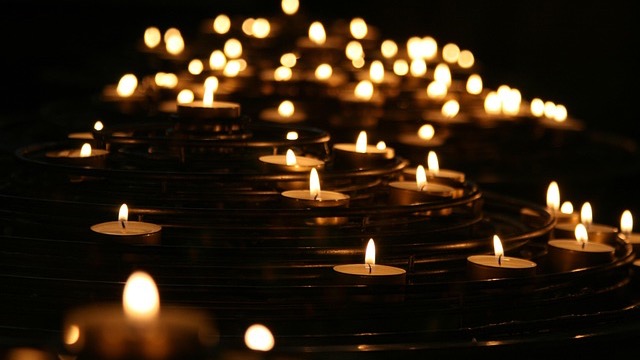 Candlelit scene featuring softly illuminated silhouette of woman.