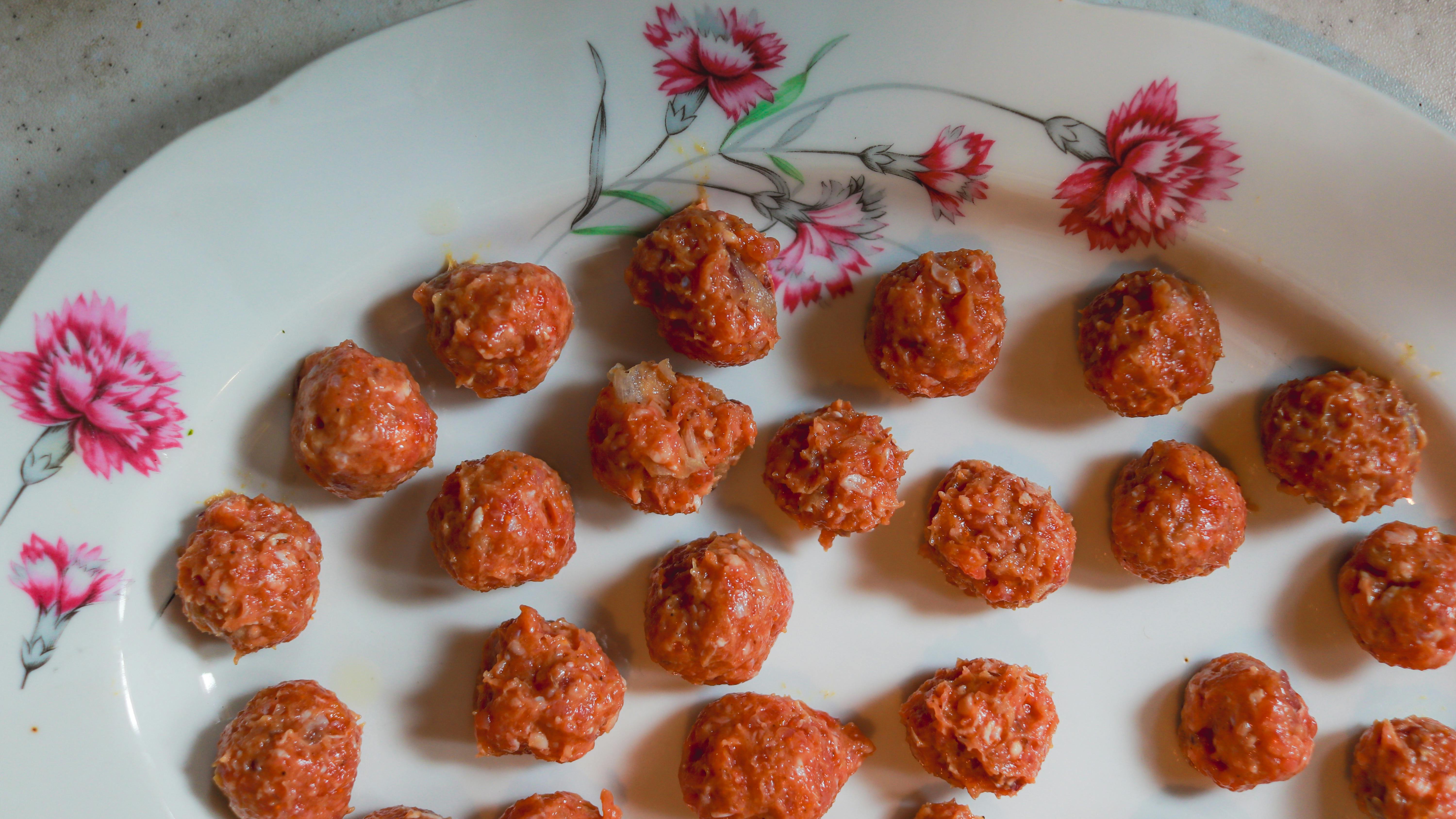 Vibrant meatball flavored lollipop with dynamic blue and yellow background.